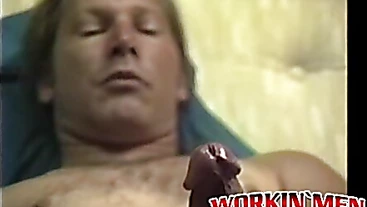 Stud Freddyz with long hair strokes his fat meat on a bed